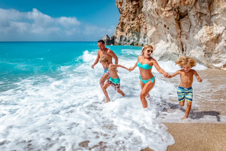 Family at a beach running through water